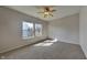 Well-lit bedroom featuring neutral walls, plush carpet, and windows providing natural light at 5467 Powder River Ct, Indianapolis, IN 46221