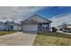 Charming single-story brick home featuring an attached garage and a well-maintained front yard at 5467 Powder River Ct, Indianapolis, IN 46221