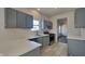 Contemporary kitchen boasts gray cabinets, stainless steel appliances, and stylish tile flooring at 5467 Powder River Ct, Indianapolis, IN 46221