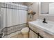 Bathroom featuring modern vanity, tiled floor, decorative mirror, and shower curtain at 5901 Crystal Bay West Dr, Plainfield, IN 46168