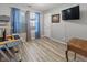 Bedroom featuring wood flooring, blue curtains, a tv and an oak table at 5901 Crystal Bay West Dr, Plainfield, IN 46168