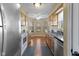 Galley kitchen featuring stainless appliances, wood cabinets and a sunny breakfast nook at 5901 Crystal Bay West Dr, Plainfield, IN 46168