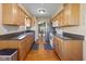 Functional galley kitchen with wood floors, stainless steel appliances, and ample cabinet space at 5901 Crystal Bay West Dr, Plainfield, IN 46168