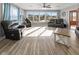 Bright living room with large windows overlooking the lake, modern furnishings and plank flooring at 5901 Crystal Bay West Dr, Plainfield, IN 46168