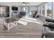 Open living room with large windows, plank flooring, and modern entertainment center at 5901 Crystal Bay West Dr, Plainfield, IN 46168