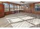 Sun room featuring many windows, natural light, wood paneled walls, and plank flooring at 5901 Crystal Bay West Dr, Plainfield, IN 46168