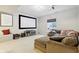 Finished basement with sectional couch, projection screen, and neutral carpet at 5944 Aldridge Dr, Whitestown, IN 46075