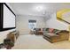 Finished basement with large sectional couch and a projection screen for entertaining at 5944 Aldridge Dr, Whitestown, IN 46075