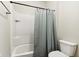 Bright bathroom features a shower-tub combination with tiled walls and a curtain at 5944 Aldridge Dr, Whitestown, IN 46075