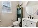 Well-lit half bathroom with a white sink and a green storage cabinet at 5944 Aldridge Dr, Whitestown, IN 46075