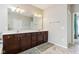 A spacious bathroom features a double vanity with dark wood cabinets and tiled floors at 5944 Aldridge Dr, Whitestown, IN 46075