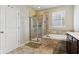 A tiled bathroom features a glass shower, soaking tub, and a double sink vanity at 5944 Aldridge Dr, Whitestown, IN 46075