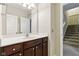 Bathroom with vanity, framed mirror, and a view of the staircase at 5944 Aldridge Dr, Whitestown, IN 46075