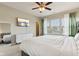 A bright, spacious bedroom featuring a ceiling fan, large windows, television, and white dresser at 5944 Aldridge Dr, Whitestown, IN 46075