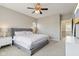 A bright bedroom with neutral colors features a ceiling fan, bedside tables, and comfortable bed at 5944 Aldridge Dr, Whitestown, IN 46075