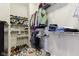 A well-organized walk-in closet with shelving and racks filled with clothing and shoes at 5944 Aldridge Dr, Whitestown, IN 46075