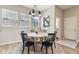 Charming dining area with a round table, six black chairs, and modern lighting at 5944 Aldridge Dr, Whitestown, IN 46075
