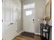 Inviting foyer with neutral walls, wood floor, white doors, and a console table with decor at 5944 Aldridge Dr, Whitestown, IN 46075
