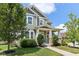 Charming two-story home with a covered porch and landscaped front yard and green horizontal siding at 5944 Aldridge Dr, Whitestown, IN 46075