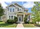 Charming two-story home with a covered porch and landscaped front yard and green horizontal siding at 5944 Aldridge Dr, Whitestown, IN 46075