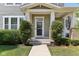 Charming two-story home with a covered porch and landscaped front yard and green horizontal siding at 5944 Aldridge Dr, Whitestown, IN 46075