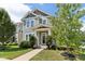 Charming two-story home with a covered porch and landscaped front yard and green horizontal siding at 5944 Aldridge Dr, Whitestown, IN 46075