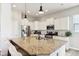 Stylish kitchen featuring stainless appliances, white cabinets, an island with granite countertops, and modern pendant lights at 5944 Aldridge Dr, Whitestown, IN 46075