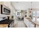 Bright kitchen featuring modern appliances, granite countertops, a kitchen island, and an open floor plan at 5944 Aldridge Dr, Whitestown, IN 46075