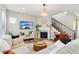 Stylish living room with a fireplace, tv, staircase, and comfortable seating area at 5944 Aldridge Dr, Whitestown, IN 46075