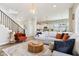 Open-concept living room featuring a cozy seating area and seamless transition to the modern kitchen at 5944 Aldridge Dr, Whitestown, IN 46075