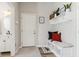 A bright and well-organized mudroom features a built-in bench with storage, decor, and white door at 5944 Aldridge Dr, Whitestown, IN 46075