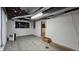 Unfinished basement space with painted block walls and view to finished area at 6040 W Thompson Rd, Indianapolis, IN 46221