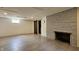Finished basement area with a stone fireplace, plank flooring and dark wood accents at 6040 W Thompson Rd, Indianapolis, IN 46221