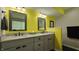 Bright, updated bathroom featuring a granite countertop, modern fixtures, and double sinks at 6040 W Thompson Rd, Indianapolis, IN 46221