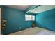 Blue bedroom with neutral carpet, window and plenty of wall space at 6040 W Thompson Rd, Indianapolis, IN 46221