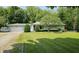 Charming single-story home featuring a well-maintained lawn, mature trees, and an attached one-car garage at 6040 W Thompson Rd, Indianapolis, IN 46221