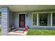 Inviting front porch with unique door decor, colorful accents, and well-kept landscaping at 6040 W Thompson Rd, Indianapolis, IN 46221