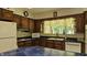 Cozy kitchen featuring wooden cabinets, blue countertops, and modern appliances at 6040 W Thompson Rd, Indianapolis, IN 46221