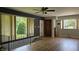 Open-concept living room with hardwood floors, neutral paint, and a view of the backyard at 6040 W Thompson Rd, Indianapolis, IN 46221