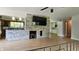 Spacious living room featuring a stone fireplace, a flat-screen TV, and hardwood floors at 6040 W Thompson Rd, Indianapolis, IN 46221