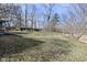 Large grassy backyard with mature trees, offering ample space for outdoor activities at 616 Gibbs Ct, Plainfield, IN 46168