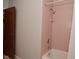 Bathroom with pink tile, white bathtub, and shower at 616 Gibbs Ct, Plainfield, IN 46168