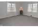 Bedroom with carpeted floors, a lamp, and two windows with curtains at 616 Gibbs Ct, Plainfield, IN 46168