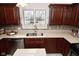 Close up of the kitchen's countertop and stainless steel double sink with large bright window at 616 Gibbs Ct, Plainfield, IN 46168