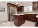 A view of the kitchen with a stainless refrigerator, kitchen island, and light countertops at 616 Gibbs Ct, Plainfield, IN 46168