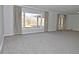 Bright living room featuring a large window with draperies and plush gray carpeting throughout at 616 Gibbs Ct, Plainfield, IN 46168