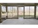 Enclosed screened porch with concrete floor and views of the backyard at 616 Gibbs Ct, Plainfield, IN 46168