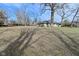 View of the house in the large yard, showing mature trees that provide shade and character at 616 Gibbs Ct, Plainfield, IN 46168