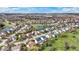 A high-angle aerial view captures a residential area featuring a scenic pond surrounded by well-maintained homes at 6571 Hunters S Rdg, Zionsville, IN 46077