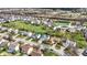 Expansive aerial view of a neighborhood with lush green spaces and a tranquil pond in the distance at 6571 Hunters S Rdg, Zionsville, IN 46077